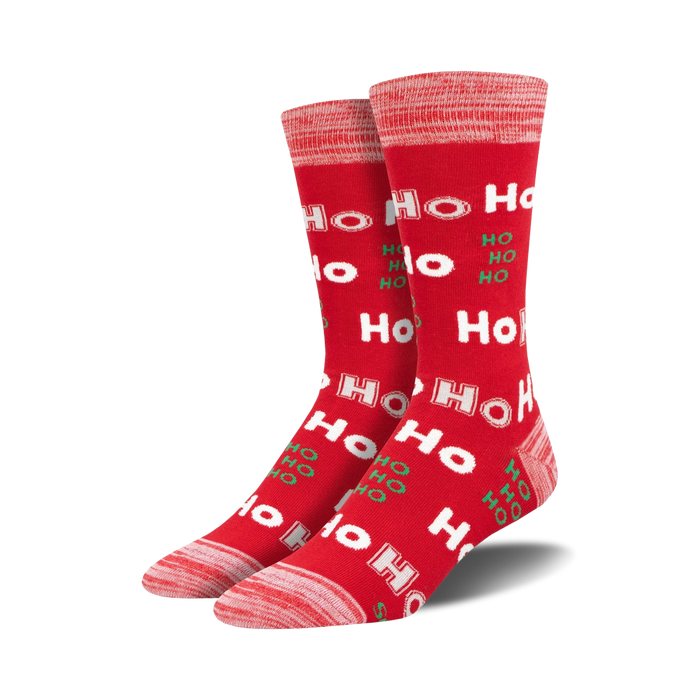 Pair of crew socks in red and green, featuring a repeated 'Ho Ho Ho' pattern.