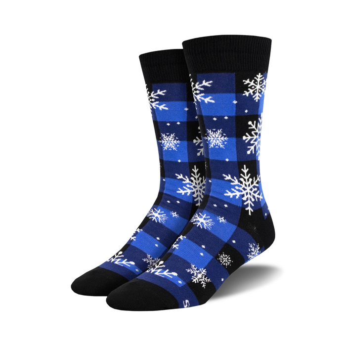 Pair of crew socks in blue and black buffalo plaid with white snowflake design.  }}