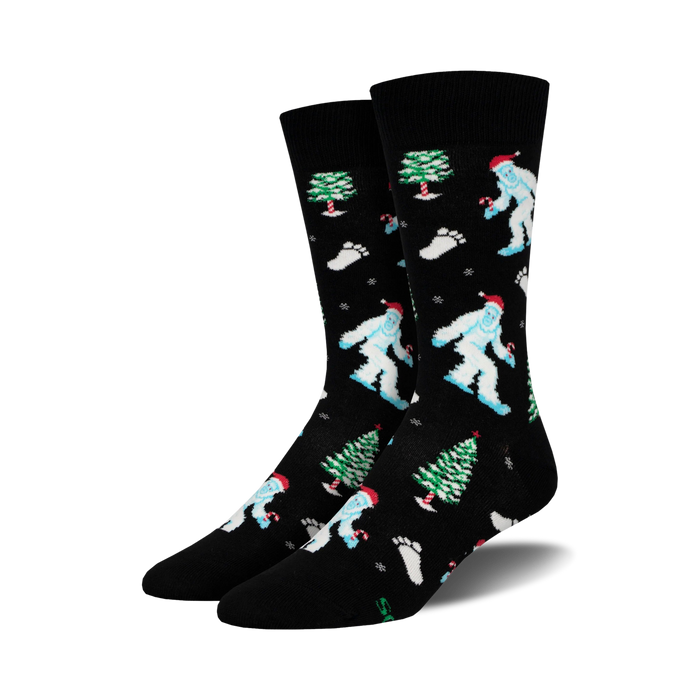 A pair of black crew socks with a whimsical Christmas design.  Features light blue Yetis in Santa hats, green Christmas trees, and candy canes. }}