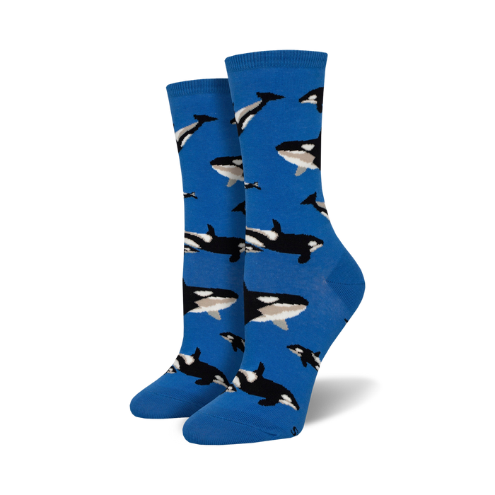 Pair of women's crew socks in bright blue, adorned with a repeating pattern of black and white orca whales. }}