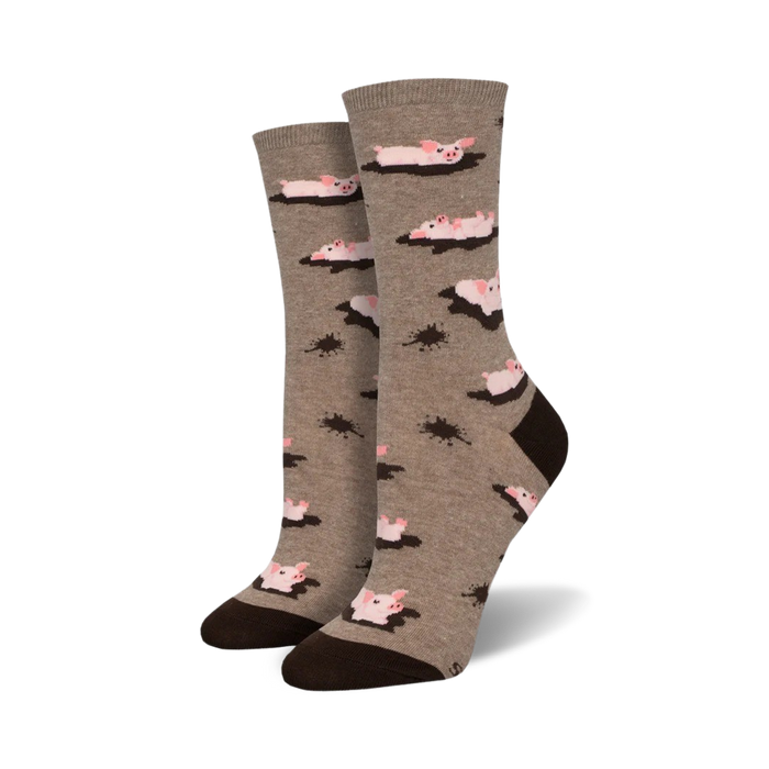Pair of taupe crew socks with a fun design. Pink pigs are shown swimming in brown mud puddles against a taupe background. Brown heel and toe. }}