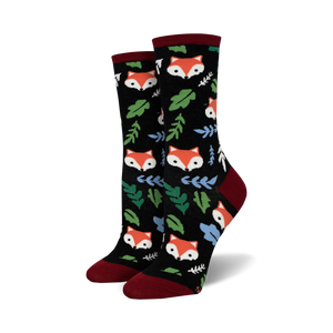 Close-up of black crew socks with foxes and leaves.  Red and green accents.