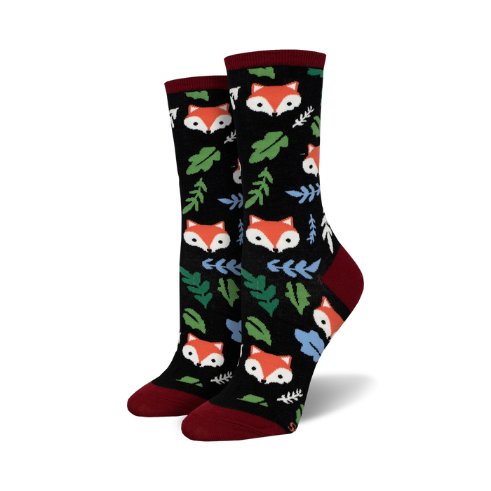 womens crew-length socks with black background and cartoon fox pattern in red, orange, green and blue.  