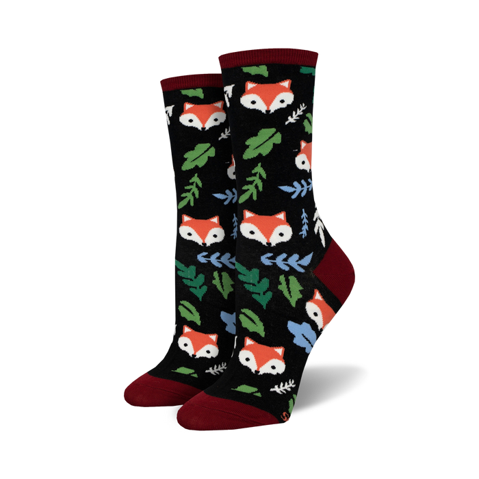 Close-up of black crew socks with foxes and leaves.  Red and green accents.