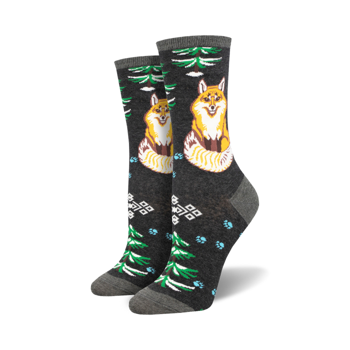 Pair of crew socks; dark gray background with orange foxes, green trees, light blue paw prints, and geometric patterns. }}