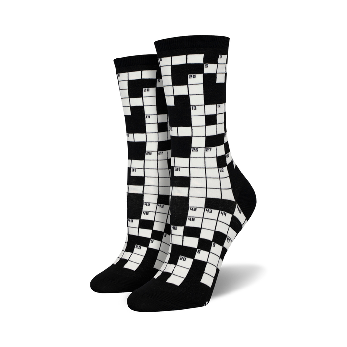 Pair of black and white crew socks featuring a crossword puzzle design. The numbers are clearly visible against the contrasting background. }}