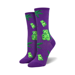 Pair of women's crew socks. Purple socks showcase green gummy bears and marijuana leaves. Black socks show the same design on a black background.