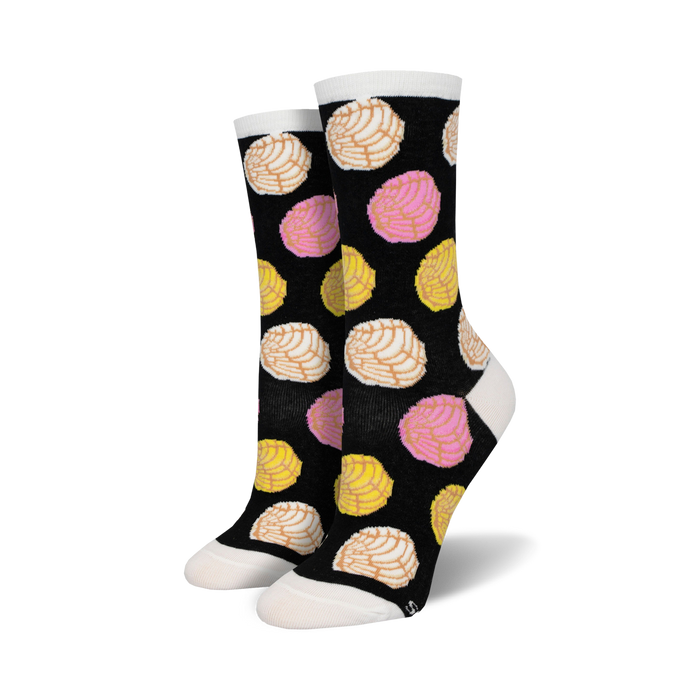 A pair of black crew socks with a fun pattern of colorful pan dulce (conchas) in pink, yellow, and white. }}