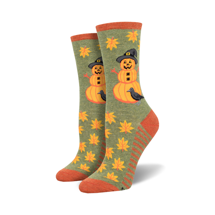 novelty halloween crew socks for women with allover fall leaves pattern and a black crow perched on a snowman made of pumpkins wearing a witch's hat.   