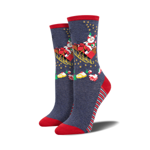 Pair of women's crew socks in navy blue with red accents.  Design features Santa in a sleigh with stars and Christmas treats.