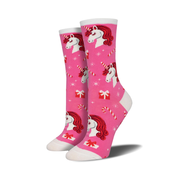 Crew socks in pink featuring red-haired unicorns, candy canes, and presents on a pink background. A festive and fun design! }}
