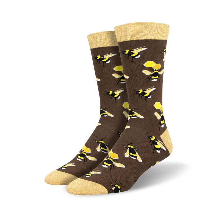 Pair of brown crew socks with a repeating pattern of yellow and black bumblebees and honeycombs.  The socks have a light yellow cuff. }}