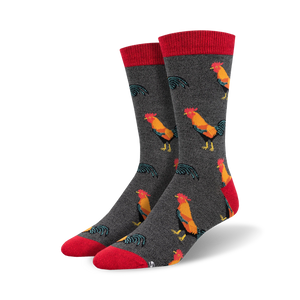 Close-up of a pair of charcoal grey crew socks with red cuffs and a repeating rooster pattern.