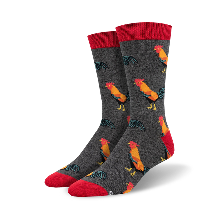 Close-up of a pair of charcoal grey crew socks with red cuffs and a repeating rooster pattern.