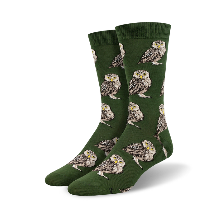 Pair of crew socks; olive green with repeating burrowing owl pattern. Owls are brown, white, and beige.