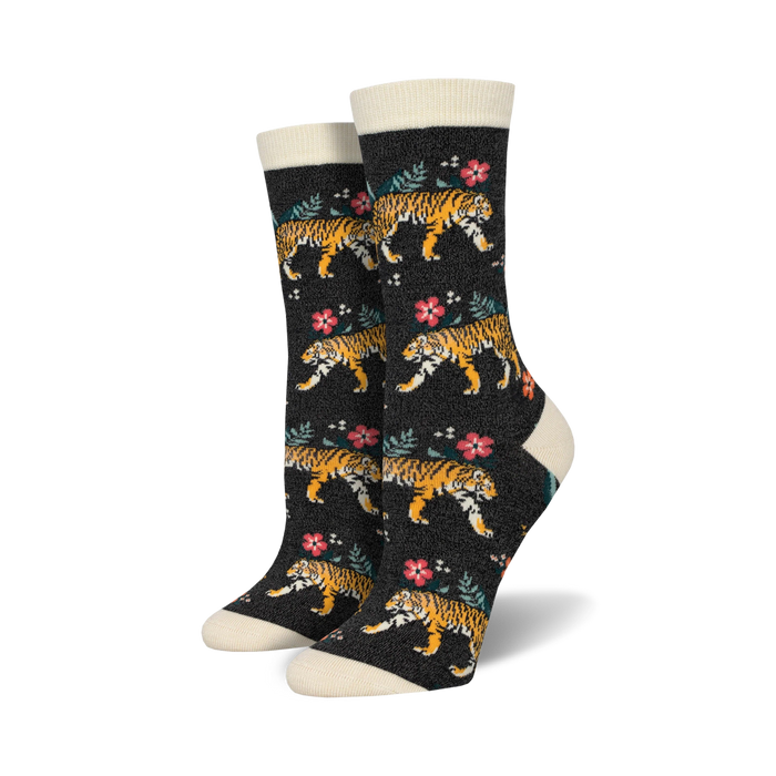 Pair of women's crew socks. Dark background with orange tigers and pink flowers.  Cream-colored cuffs.