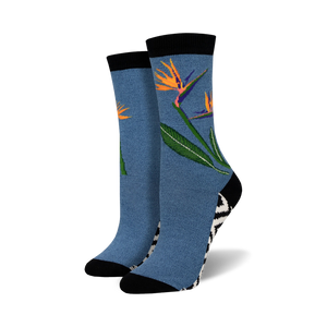 Pair of crew socks in blue featuring a bird-of-paradise flower design.  Black and white zig-zag pattern at the ankle. Soft bamboo.