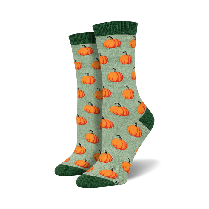 light sage green crew socks with cartoon pumpkin pattern, perfect for halloween.    }}