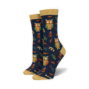 Pair of women's crew socks. Dark blue background with repeating pattern of owls, leaves, and berries. Gold top trim.