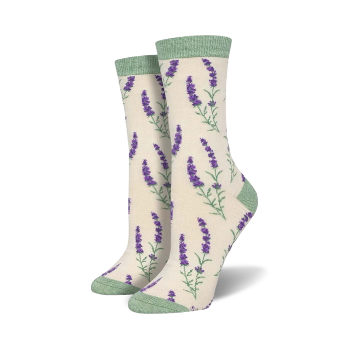 Close-up view of a pair of cream-colored crew socks with purple lavender sprigs. Light green cuffs.
