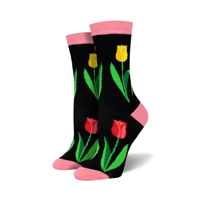Pair of women's crew socks. Black background with red, yellow tulips and green leaves. Pink top trim.