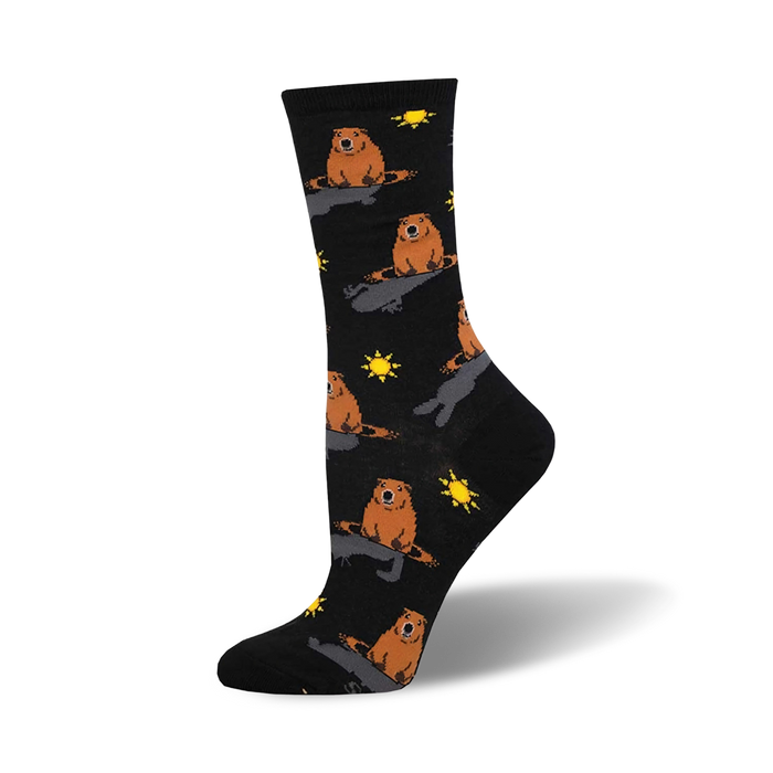 Black crew socks with a repeating pattern of orange groundhogs and yellow suns. }}