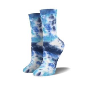 Lifestyle shot of a person wearing light blue tie-dye athletic socks.