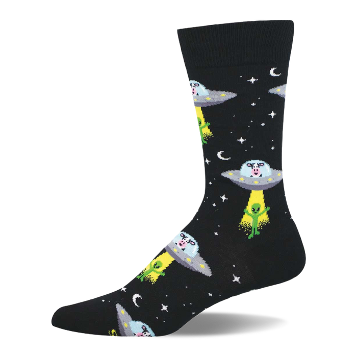 Black crew socks with a repeating pattern of grey UFOs abducting green aliens, with cow heads visible inside the saucers. }}