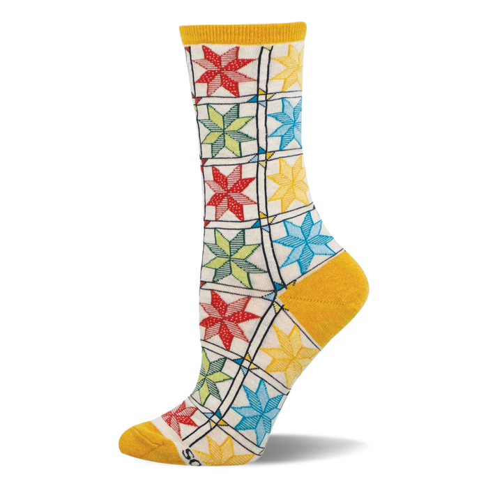 Single crew sock with colorful quilt pattern: red, green, blue, yellow star blocks on cream, with mustard heel, toe, cuff. }}