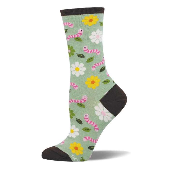 Light green crew socks with pink smiling worms, white and yellow flowers, and green leaves. Dark brown heel, toe, and cuff. }}