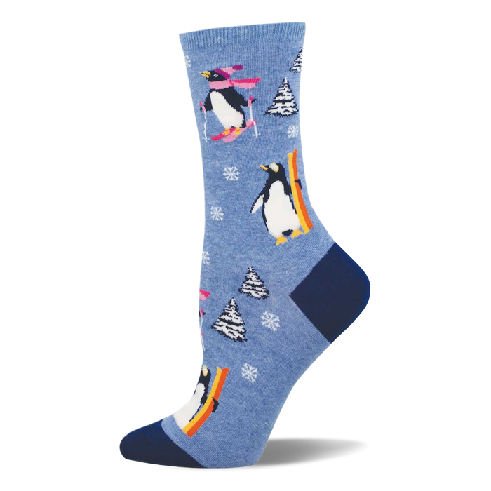 Light blue crew sock with skiing and snowboarding penguins, white snowflakes, and snow-covered pine trees. Dark blue heel and toe. }}