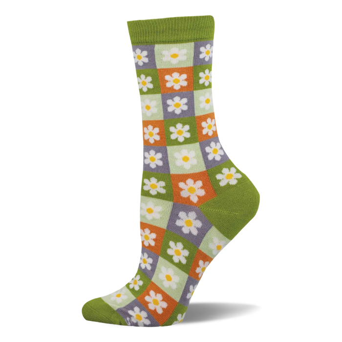 Side view of a crew sock with a checkerboard of light green, orange, and purple squares, each with a white daisy. Dark green cuff, heel, and toe. }}