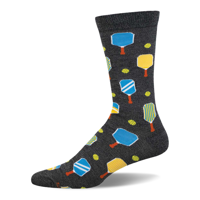 Dark grey crew socks featuring a pickleball pattern with blue and yellow paddles, orange handles, and yellow pickleballs. }}