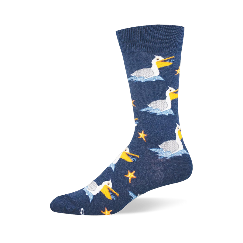 Navy blue crew sock showing a pattern of white pelicans floating on blue waves, holding fish near orange starfish.