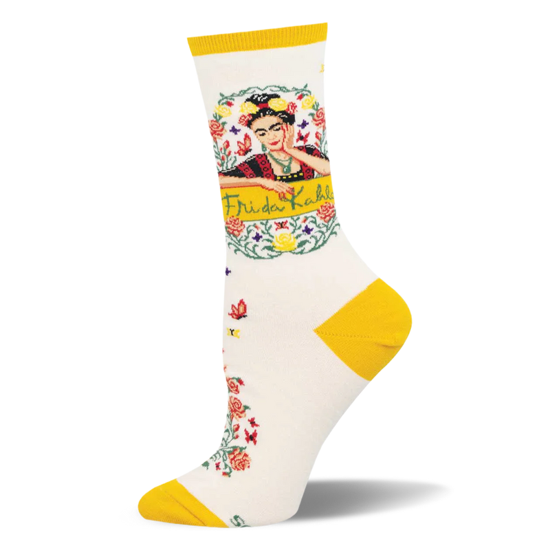 Cream crew sock featuring bright yellow accents, a framed Frida Kahlo portrait, and a trail of red floral vines.
