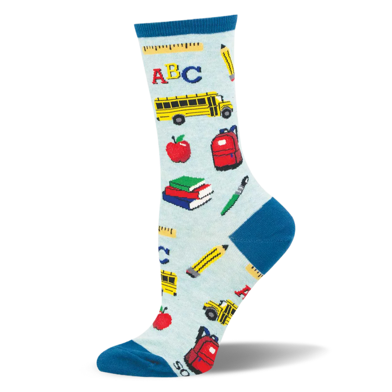 Light blue socks with teal accents, covered in a pattern of school buses, red apples, books, and pencils.
