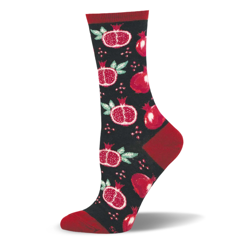 Black crew socks featuring a pattern of whole red pomegranates, halved pomegranates with seeds, and matching red heels.
