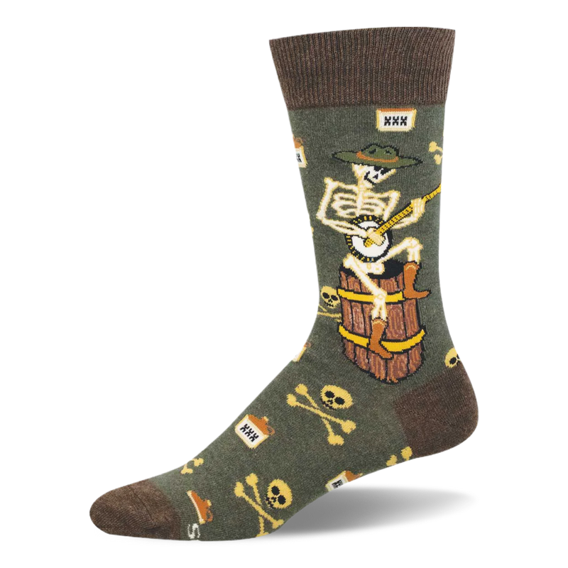 Olive green crew socks showing a skeleton in a hat and boots playing a banjo on a barrel, plus skulls and XXX moonshine jugs.