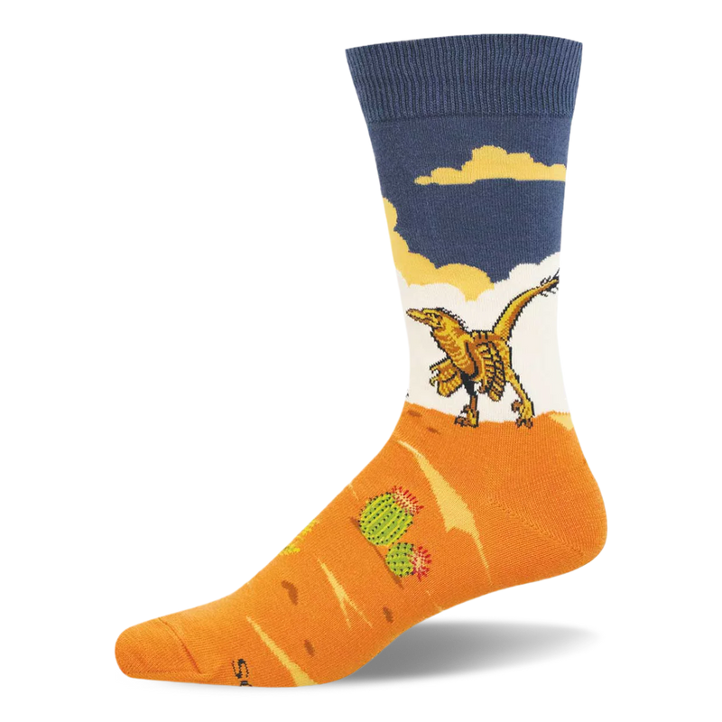 Crew sock with a yellow feathered velociraptor walking on an orange desert landscape with a green cactus under a blue sky.