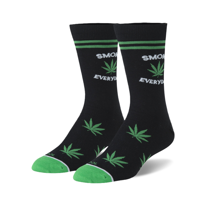 Pair of black crew socks with green marijuana leaf designs and 'Smoke Everyday' text. Green accents on the cuffs.