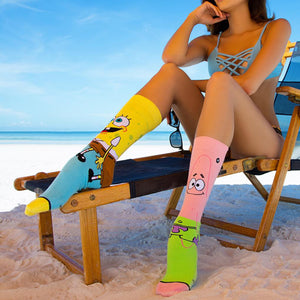 Lifestyle shot of a woman wearing the Spongebob and Patrick socks on the beach.