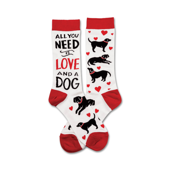A pair of crew socks with a red and white design.  The socks feature black labrador silhouettes, red hearts, and the text 'All You Need Is Love And A Dog'. }}