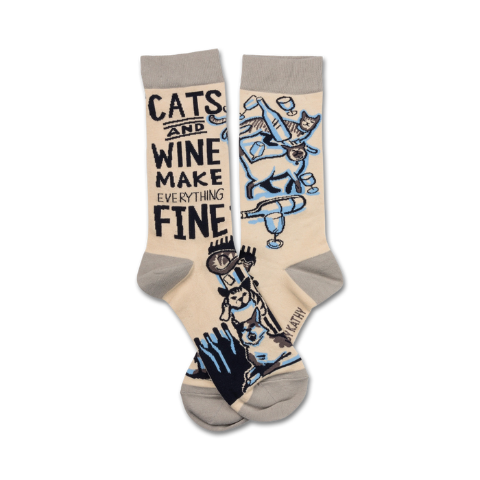 Cream crew socks with a fun design.  Features illustrations of cats and wine glasses, plus the text: 'Cats and wine make everything fine'. }}