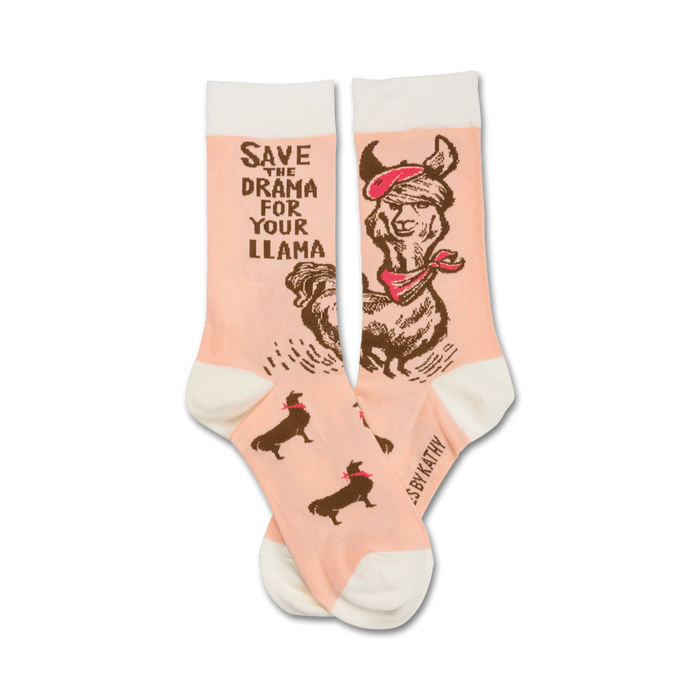 Crew socks in peach with a brown illustration of a llama wearing a beret and bandana. Text reads: 'Save the drama for your llama'. }}