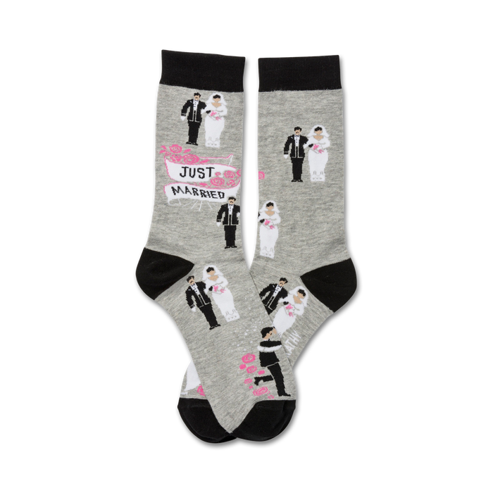 Pair of grey crew socks with black cuffs. Features repeating pattern of cartoon bride and groom illustrations and a 'Just Married' banner. }}
