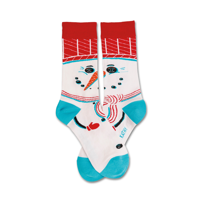 A pair of crew socks featuring a whimsical snowman design. The socks are primarily white with red, teal, and black accents. }}