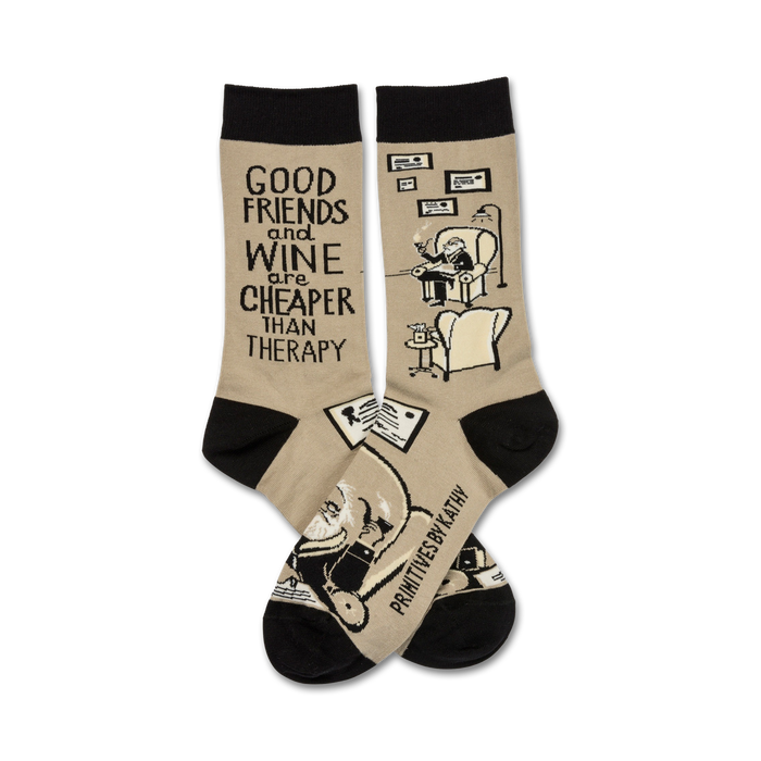 A pair of beige crew socks with black cuffs.  They feature a funny illustration of a man relaxing with wine and the text 'Good friends and wine are cheaper than therapy'. }}
