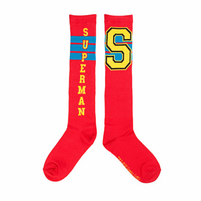Pair of red knee-high socks. One sock displays 'SUPERMAN' vertically, the other a large yellow 'S' with blue trim. Both have thin blue stripes.