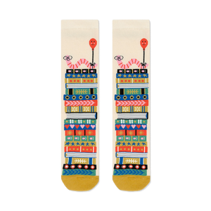 Cream crew socks with a whimsical design of colorful book stacks and pink worms holding balloons.