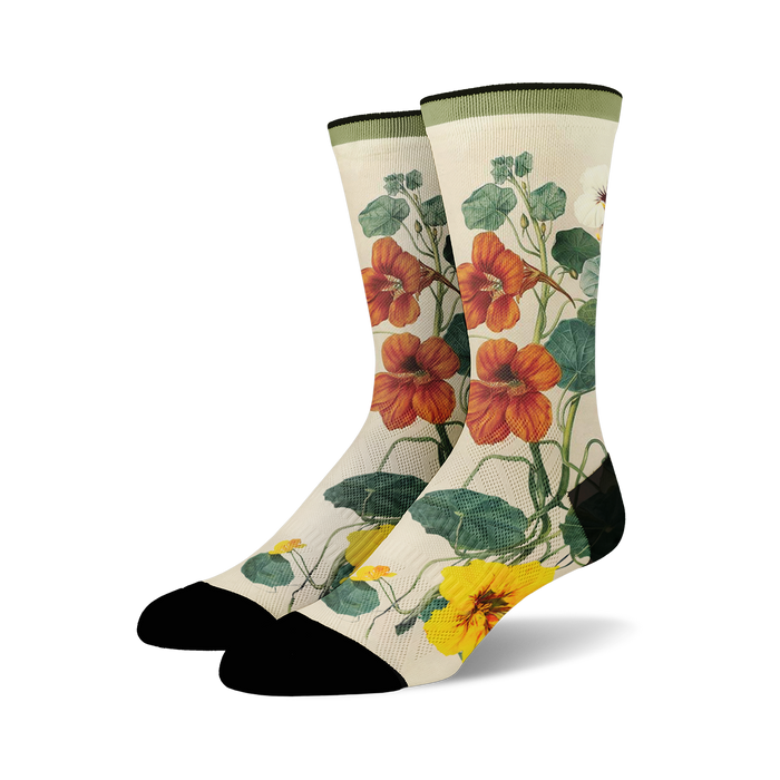 Pair of crew socks with a botanical print.  Features orange and yellow nasturtium flowers and green leaves on a cream background. Black toe and heel. }}